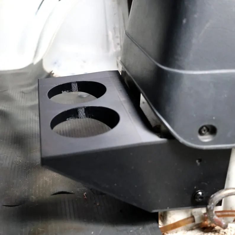 Black double cup holder bolted to the side of the Honda Acty HA4 center console