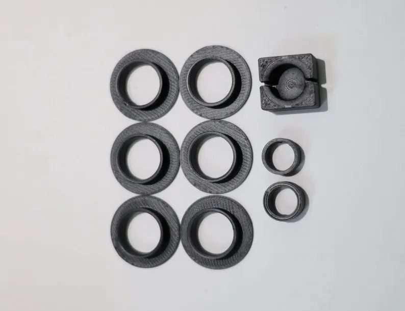Honda Acty shift linkage bushing kit: six shifter assembly bushings, a ball cup and two small linkage bushings laid out on a white background